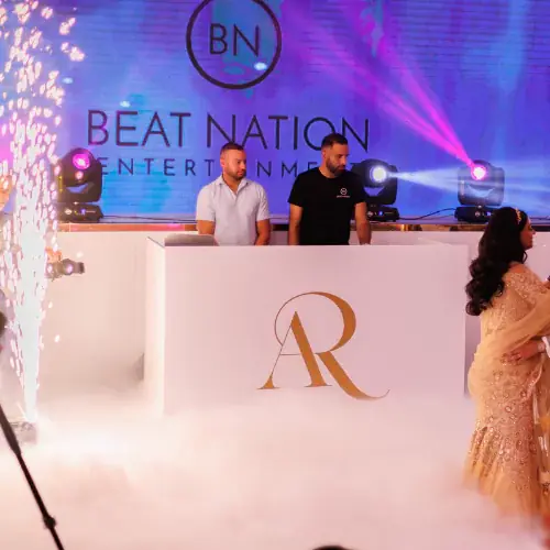 Cold spark fountains beside the DJ booth during a first dance