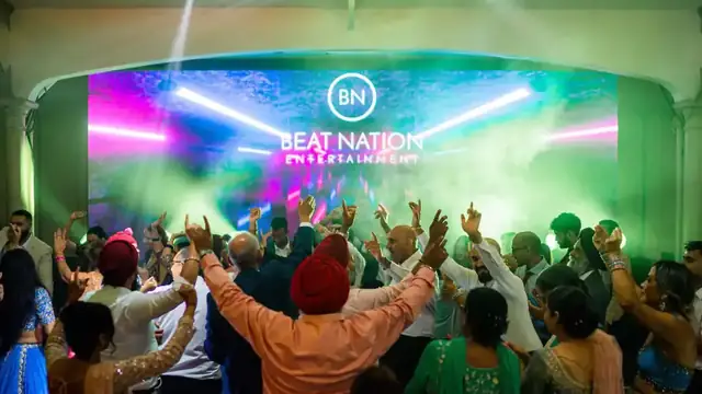 Guests dancing under a Beat Nation LED wall