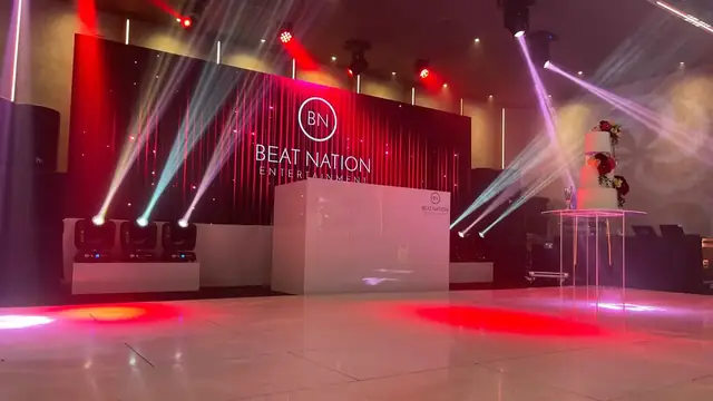 DJ booth with red and purple lights ready for a sangeet